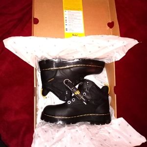 These are new black Doc Martens, never worn, new laces, steel toe work boot